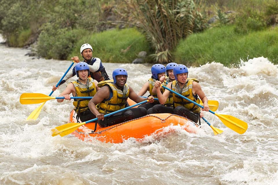 six men rafting along the river as they have fan