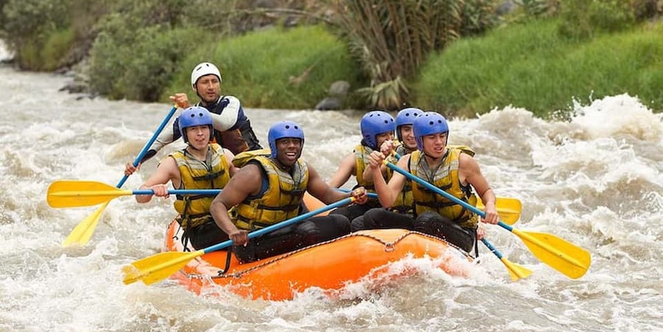 six men rafting along the river as they have fan